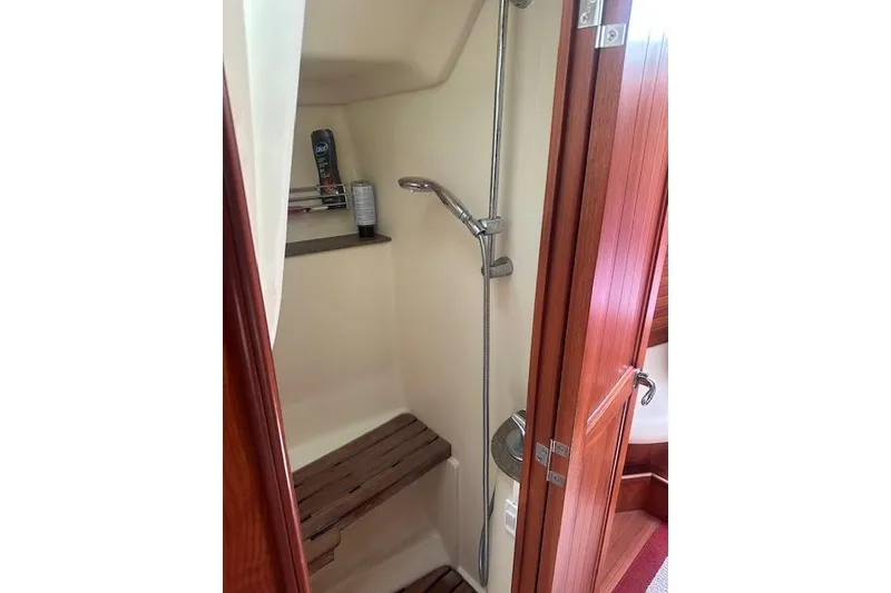 Slide: The Image of Cozy cabin interior of 2011 Hunter Aft Cockpit 50 with striped bedding and red accents. - 27