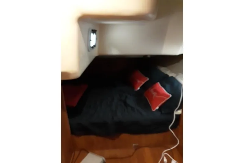 Slide: The Image of Cozy cabin interior of 2011 Hunter 50 Aft Cockpit with striped bedding. - 28