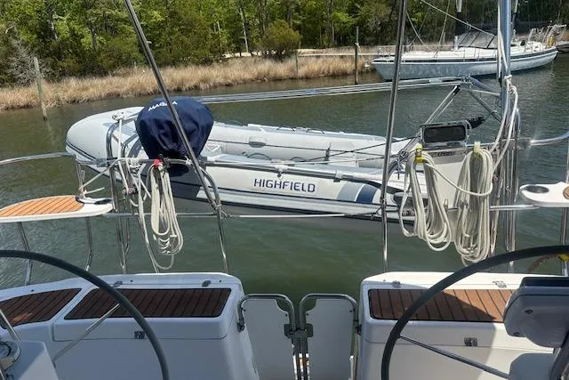 Slide: The Image of Hunter Aft Cockpit 50 sailboat, 2011 model, with a Highfield dinghy on the water. - 3