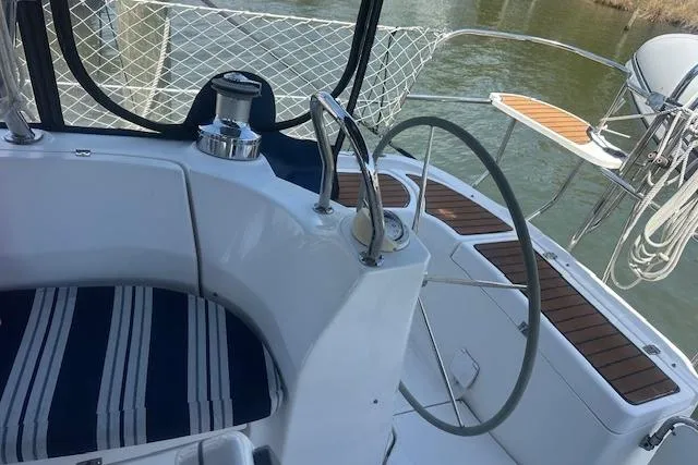 Slide: The Image of Cockpit of 2011 Hunter Aft Cockpit 50 sailboat with striped seating and steering wheel. - 4