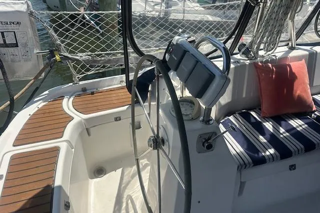 Slide: The Image of Cockpit of 2011 Hunter Aft Cockpit 50 sailboat with striped seating and steering wheel. - 5