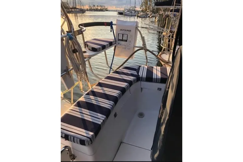 Slide: The Image of Aft cockpit of 2011 Hunter 50 sailboat with striped cushions, docked at marina. - 8