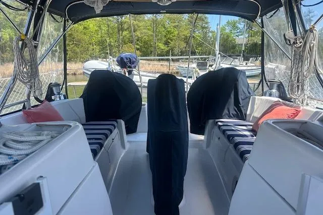 Slide: The Image of Spacious cockpit of 2011 Hunter Aft Cockpit 50 sailboat with covered seating and scenic marina view. - 9