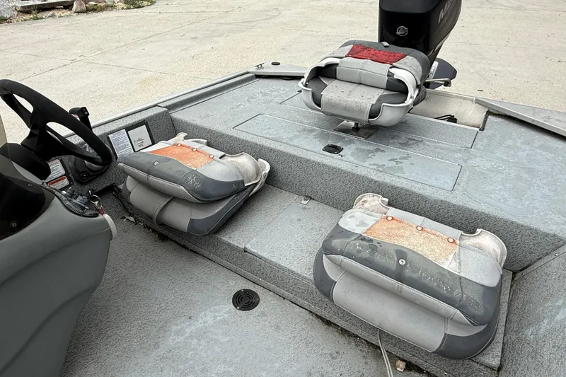 Slide: The Image of 2016 Tracker Pro 170 boat interior with worn seats and steering wheel. - 10