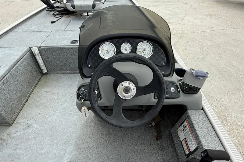 Slide: The Image of 2016 Tracker Pro 170 boat dashboard with steering wheel and gauges. - 11