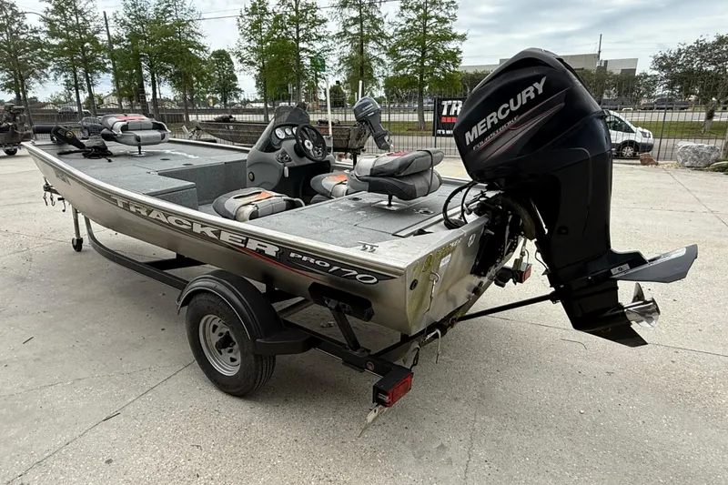 Slide: The Image of 2016 Tracker Pro 170 boat with Mercury outboard motor, parked on a trailer. - 4