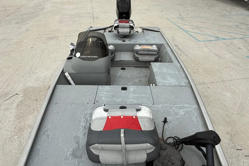 Slide: The Image of 2016 Tracker Pro 170 boat interior with seating and controls on concrete surface. - 9