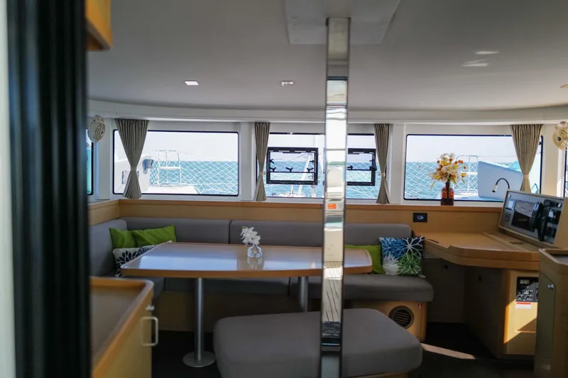 Slide: The Image of Interior of 2018 Lagoon 42 catamaran with dining area and ocean view. - 15