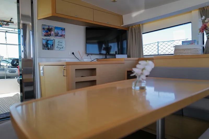 Slide: The Image of Interior of 2018 Lagoon 42 catamaran with modern decor and a cozy seating area. - 25