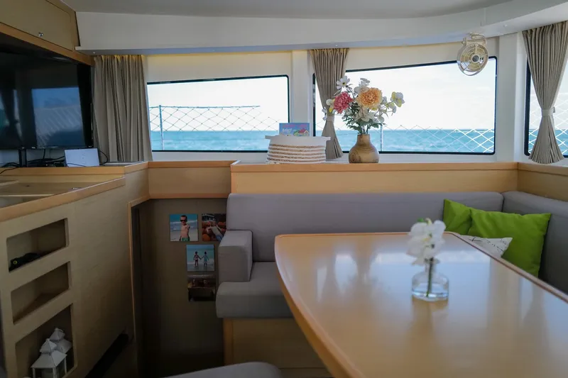 Slide: The Image of Interior of a 2018 Lagoon 42 catamaran with elegant dining area and ocean view. - 26