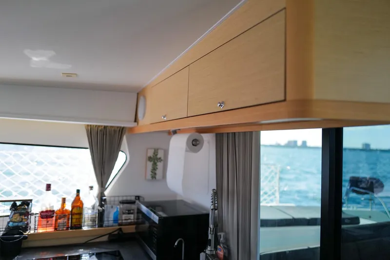 Slide: The Image of Interior of 2018 Lagoon 42 yacht kitchen with ocean view through window. - 27