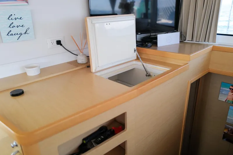 Slide: The Image of Interior of 2018 Lagoon 42 yacht with open storage compartment and modern decor. - 29