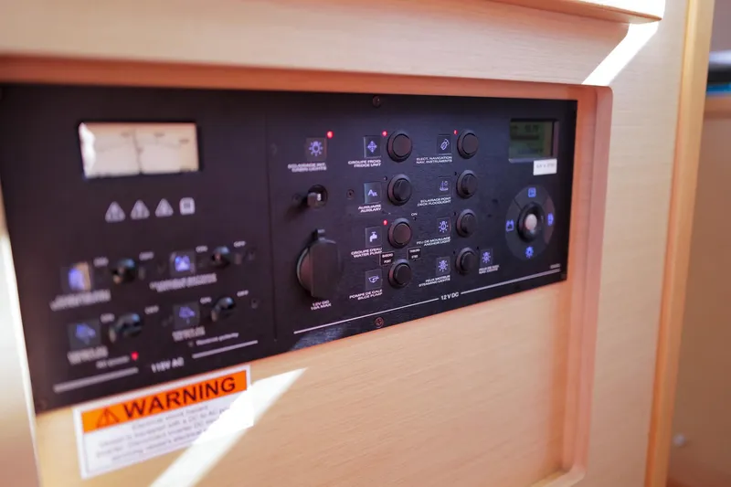 Slide: The Image of Control panel of a 2018 Lagoon 42 catamaran with various switches and warning label. - 31