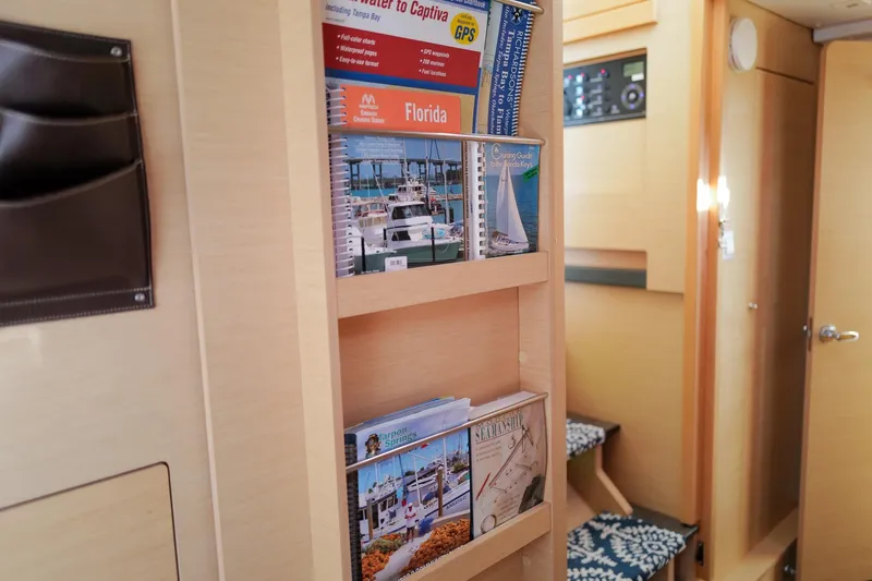 Slide: The Image of Interior of a 2018 Lagoon 42 yacht with nautical guides and brochures. - 33