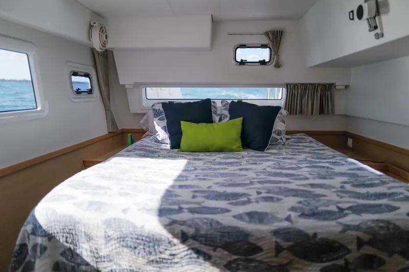 Slide: The Image of Cozy cabin interior of 2018 Lagoon 42 catamaran with bed and ocean view. - 34