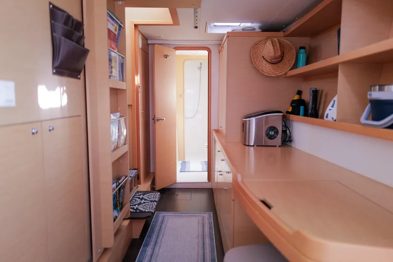 Slide: The Image of Interior of 2018 Lagoon 42 catamaran with modern wooden cabinetry and nautical decor. - 36