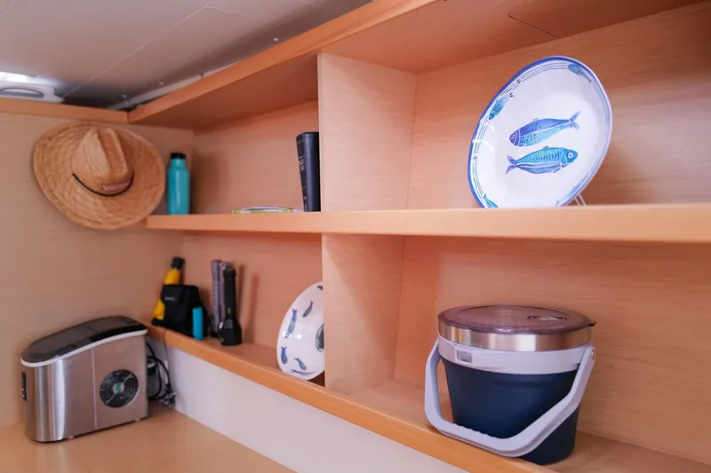 Slide: The Image of Interior of 2018 Lagoon 42 yacht with shelves, decor, and kitchen items. - 37