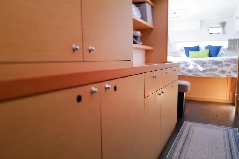 Slide: The Image of Interior of 2018 Lagoon 42 yacht with wooden cabinets and cozy bedroom. - 38