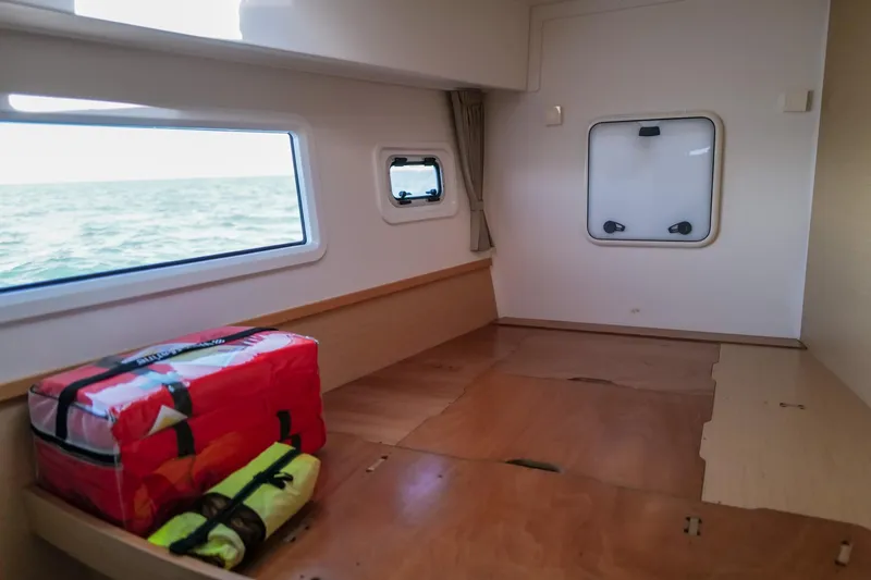 Slide: The Image of Interior cabin of 2018 Lagoon 42 catamaran with ocean view and safety equipment. - 45
