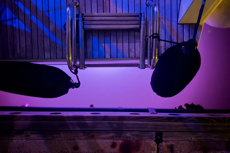 Slide: The Image of Top view of Lagoon 42 yacht deck with purple lighting, 2018 model. - 8