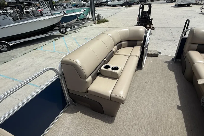 Slide: The Image of 2021 Sun Tracker Party Barge 20 DLX with beige seating and cup holders on deck. - 10