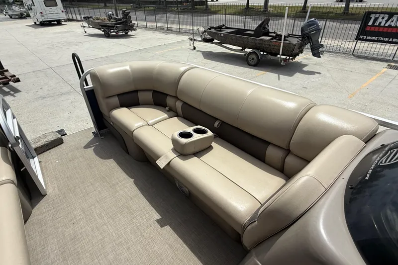 Slide: The Image of 2021 Sun Tracker Party Barge 20 DLX with beige seating and cup holders. - 11