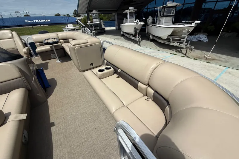 Slide: The Image of 2021 Sun Tracker Party Barge 20 DLX with beige seating and spacious deck layout. - 13