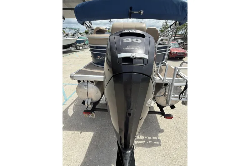 Slide: The Image of 2021 Sun Tracker Party Barge 20 DLX with Mercury 90 engine, docked outdoors. - 5