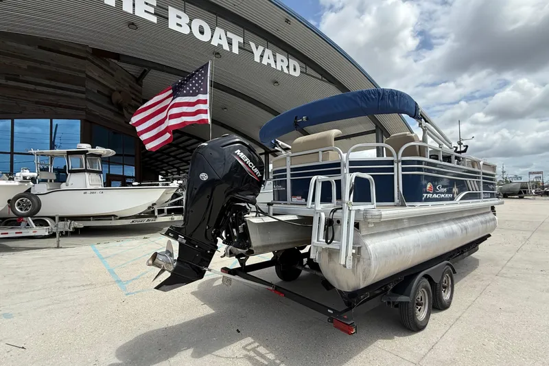Slide: The Image of 2021 Sun Tracker Party Barge 20 DLX pontoon boat at The Boat Yard with American flag. - 6