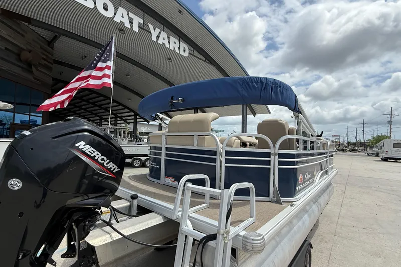 Slide: The Image of 2021 Sun Tracker Party Barge 20 DLX pontoon boat at a boat yard with Mercury engine. - 7