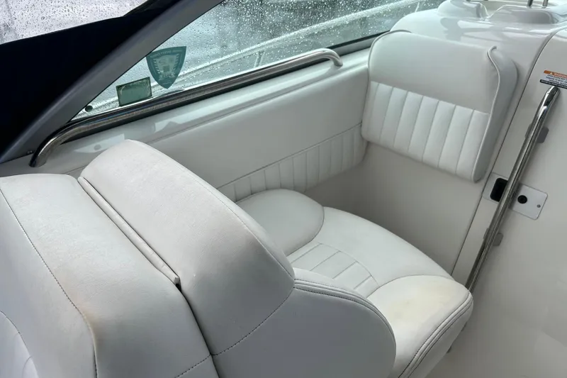 Slide: The Image of 2011 Robalo R265 Walkaround boat interior with white cushioned seating. - 10