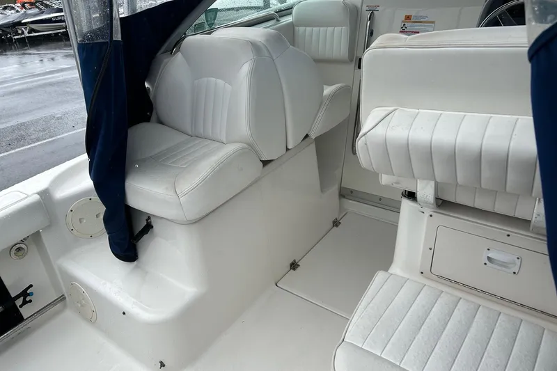 Slide: The Image of 2011 Robalo R265 Walkaround boat interior with white seating and blue accents. - 22