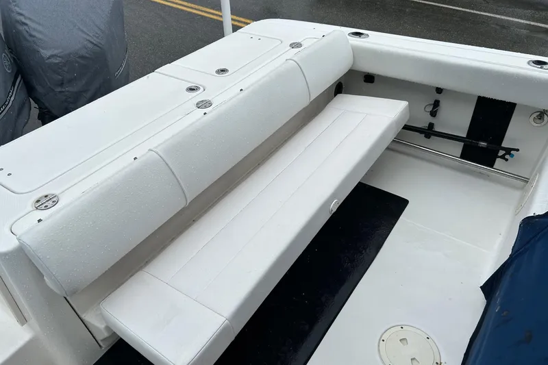 Slide: The Image of 2011 Robalo R265 Walkaround boat interior with white seating and storage compartments. - 26