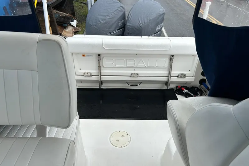 Slide: The Image of 2011 Robalo R265 Walkaround boat interior with seating and engine covers. - 27