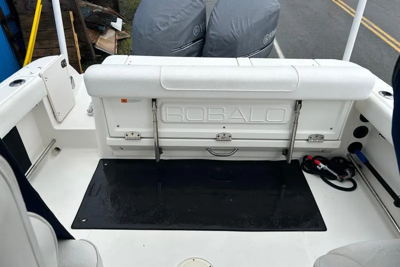Slide: The Image of 2011 Robalo R265 Walkaround boat interior with seating and storage area. - 28