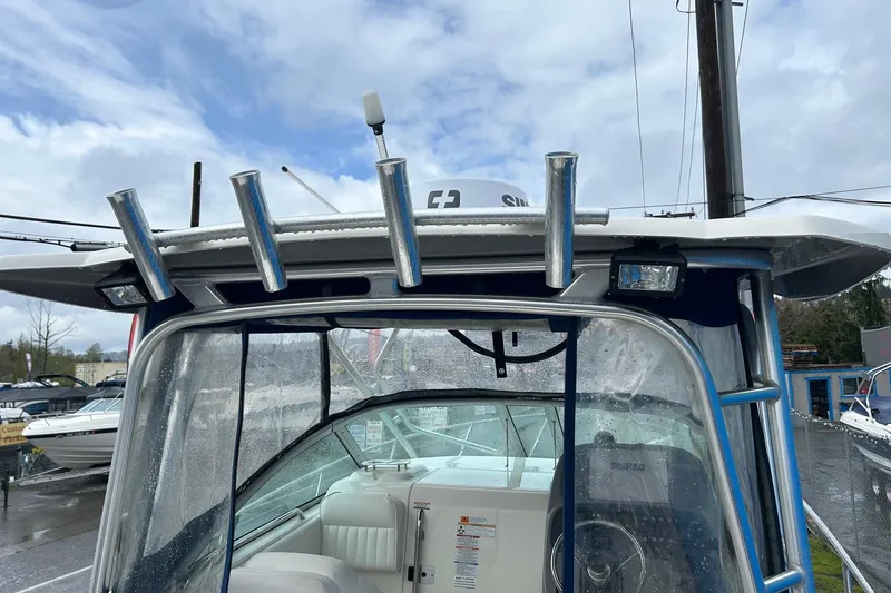 Slide: The Image of 2011 Robalo R265 Walkaround boat with rod holders and clear canopy. - 29
