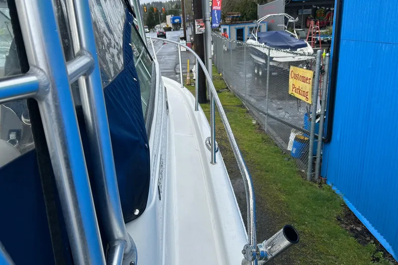 Slide: The Image of 2011 Robalo R265 Walkaround boat parked near a customer parking area. - 31