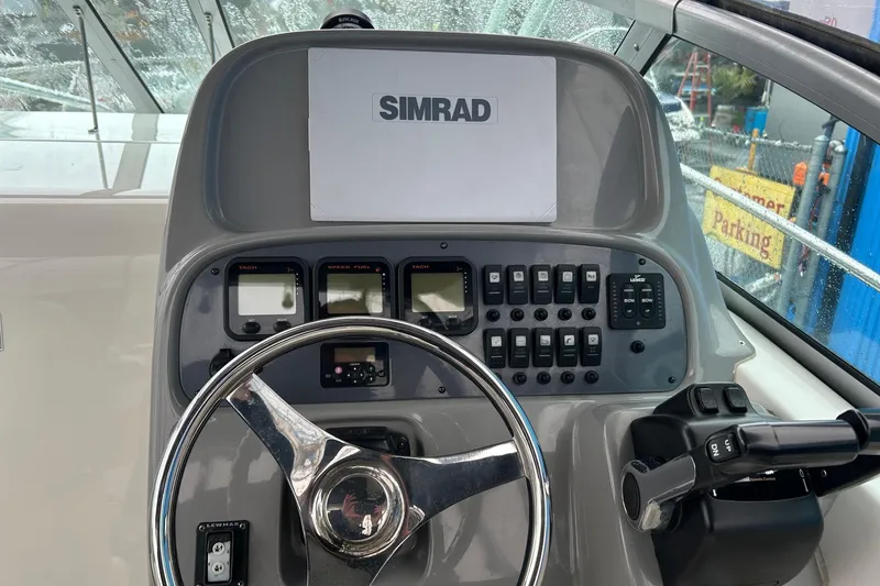 Slide: The Image of 2011 Robalo R265 Walkaround helm with Simrad display and control panel. - 5