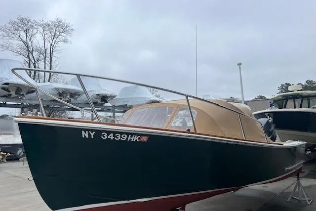 Slide: The Image of 1993 Padebco V-21 boat with tan canopy, docked in a marina. - 10