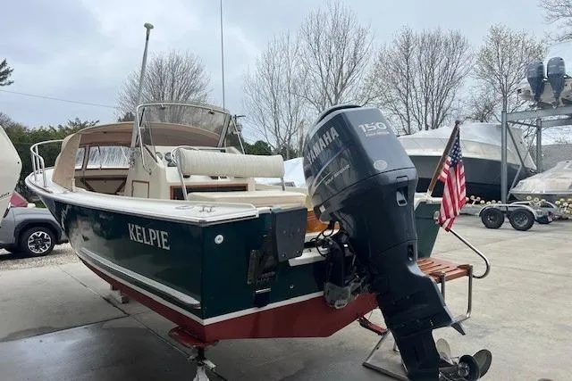 Slide: The Image of 1993 Padebco V-21 boat with Yamaha 150 engine, docked outdoors. - 11