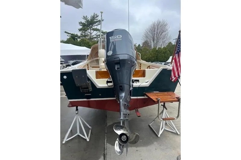 Slide: The Image of 1993 Padebco V-21 boat with outboard motor and American flag, docked outdoors. - 12