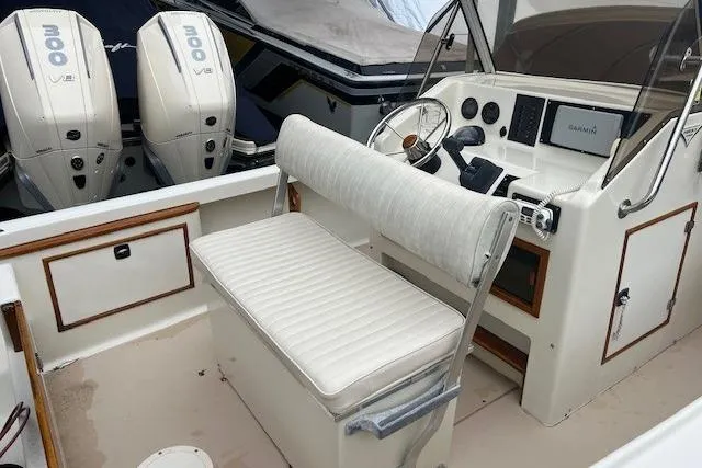 Slide: The Image of 1993 Padebco V-21 boat interior with seating, steering wheel, and dual engines. - 13