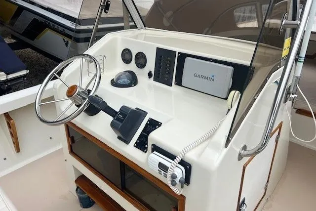 Slide: The Image of 1993 Padebco V-21 boat helm with Garmin navigation system and classic steering wheel. - 15