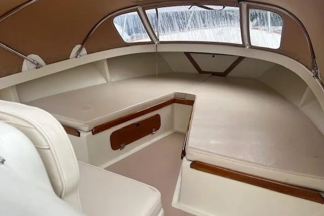 Slide: The Image of Interior of 1993 Padebco V-21 boat with cushioned seating and tan canopy. - 16