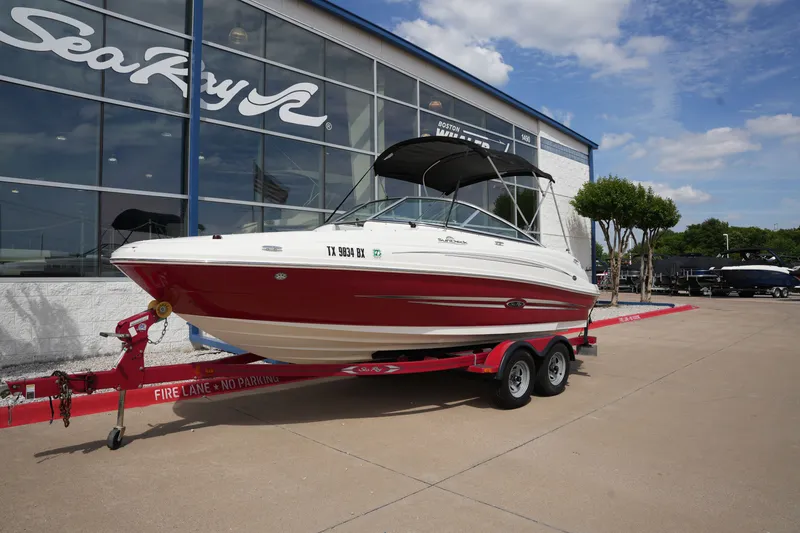 Slide: The Image of 2011 Sea Ray 200 Sundeck on trailer outside showroom. - 1