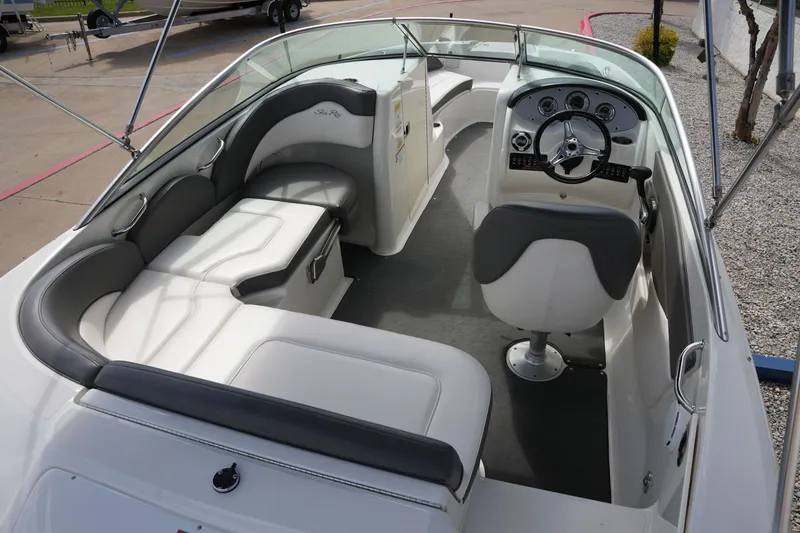 Slide: The Image of Interior of a 2011 Sea Ray 200 Sundeck boat with gray and white seating. - 10