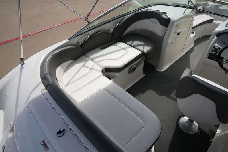 Slide: The Image of Interior of a 2011 Sea Ray 200 Sundeck boat with seating area. - 11