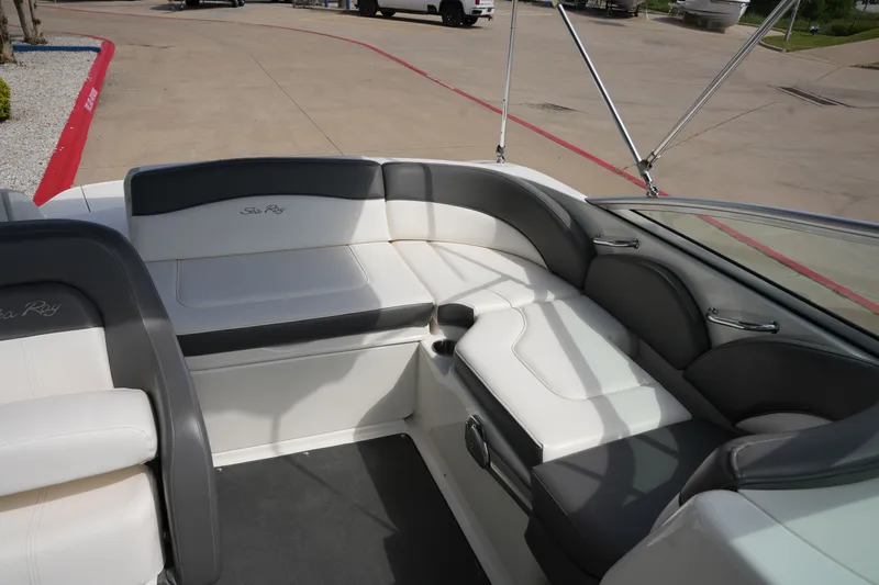 Slide: The Image of Interior of a 2011 Sea Ray 200 Sundeck boat with gray and white seating. - 12
