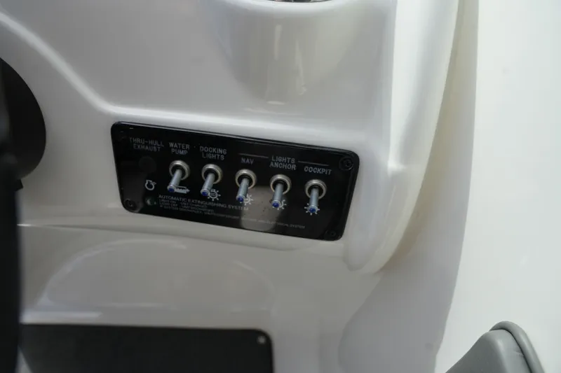 Slide: The Image of Control panel of 2011 Sea Ray 200 Sundeck with toggle switches. - 22