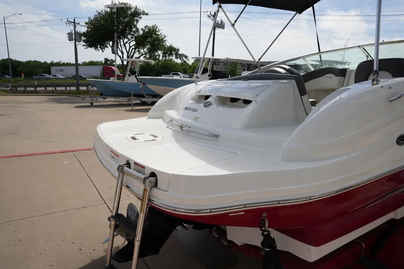 Slide: The Image of 2011 Sea Ray 200 Sundeck boat on a parking lot. - 8